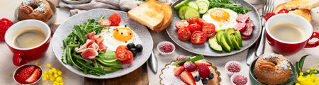Breakfast served with coffee, fresh bakery, eggs, salad, meat and fruits. Holiday concept. Top view. Panorama.の写真素材