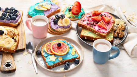Sweet breakfast with cup of cocoa. Toast with cream cheese, banana, strawberries, blueberries. Top viewの写真素材