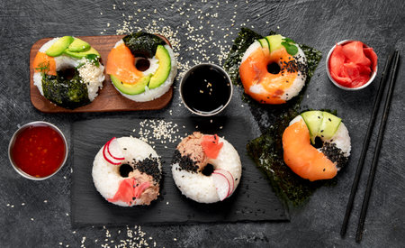 Sushi donuts on a dark background. Hybrid trend food. Top viewの写真素材