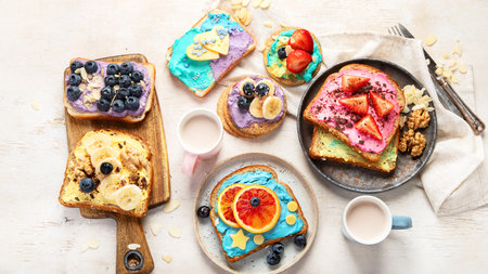 Sweet breakfast with cup of cocoa. Toast with cream cheese, banana, strawberries, blueberries. Top viewの写真素材
