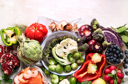 Vegetables, fish, berry on wooden background. Healthy food concept. Top view, copy spaceの写真素材