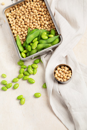 Soybeans on light cotton and wooden background. Vegan food concept. Top view, copy spaceの写真素材