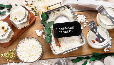 DIY. Crafting white aroma candles on light wood background. Top viewの写真素材