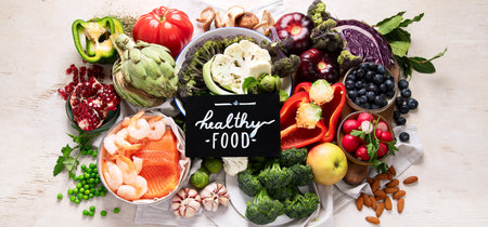 Vegetables, fish, berry on wooden background. Healthy food concept. Top view, bannerの写真素材