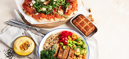 Vegetarian food concept. Set of healthy vegetarian food, salad, avocado, pizza and buddha bowl on a light background, top view. Panorama with copy space.の写真素材