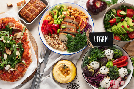 Vegetarian food concept. Set of healthy vegetarian food, salad, avocado, pizza and buddha bowl on a light background, top view.の写真素材