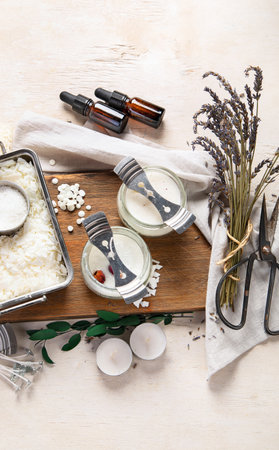 DIY. Crafting white aroma candles on light wood background. Top viewの写真素材