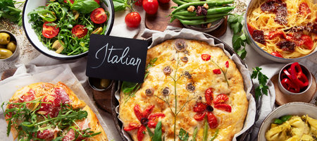 Table of Italian meals. Pizza, pasta, ravioli, focaccia on white background. Healthy eating concept. Top view. Panorama.の写真素材