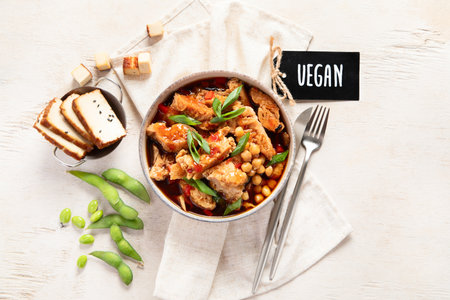 Soybean with soy meat, onion and tofu on light wooden background. Vegan food. Top viewの写真素材