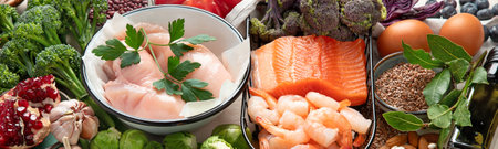 Balanced diet food background. Healthy food selection. Detox and clean diet concept. Foods high in vitamins, minerals and antioxidants. Anti age foods. Top view. Panorama with copy space.の写真素材