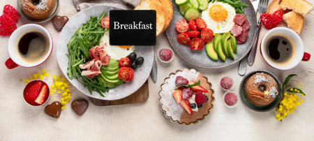 Breakfast served with coffee, fresh bakery, eggs, salad, meat and fruits. Holiday concept. Top view. Copy space.の写真素材