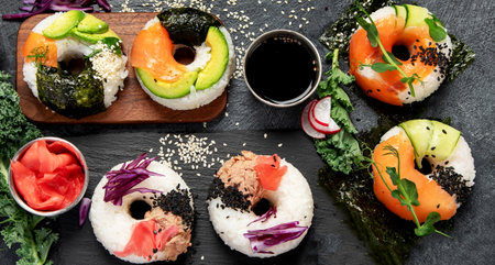Sushi donuts on a dark background. Hybrid trend food. Top viewの写真素材
