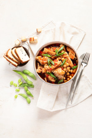 Soybean with soy meat, onion and tofu on light wooden background. Vegan food. Top view, copy spaceの写真素材
