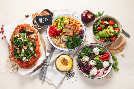 Vegetarian food concept. Set of healthy vegetarian food, salad, avocado, pizza and buddha bowl on a light background, top view.の写真素材