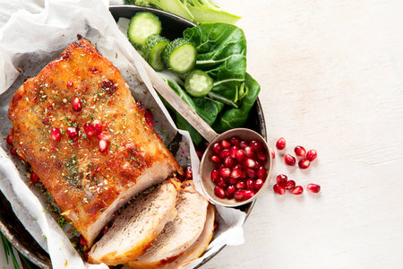 Sliced baked ham with salad on light wooden background. Traditional food concept. Top view, copy spaceの写真素材