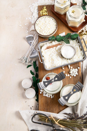DIY. Crafting white aroma candles on light wood background. Top view, copy spaceの写真素材