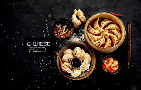 Chinese dumplings, soy sauce, mushrooms on dark background. traditional asian food concept. Top viewの写真素材