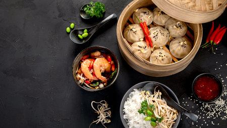 Chinese hot food. Dumplings, soy sauce, shrimp on black background. Traditional Asian lunch. Top view, copy spaceの写真素材