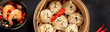 Chinese hot food. Dumplings, soy sauce, shrimp on black background. Traditional Asian lunch. Top view, bannerの写真素材