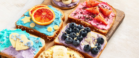Sweet breakfast. Colorful toasts with fruits and berries. Children's food conceptの写真素材