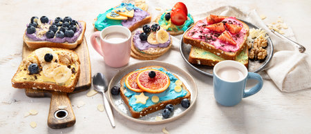 Sweet breakfast with cup of cocoa. Toast with cream cheese, banana, strawberries, blueberries. Panoramaの写真素材