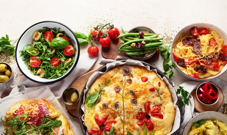 Table of Italian meals. Pizza, pasta, ravioli, focaccia on white background. Healthy eating concept. Top view. Copy space.の写真素材