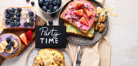 Sweet toast assortment. Banana, cream cheese, peanut butter and strawberry, cream cheese and blueberry on a white background. Top view. Copy space.の写真素材