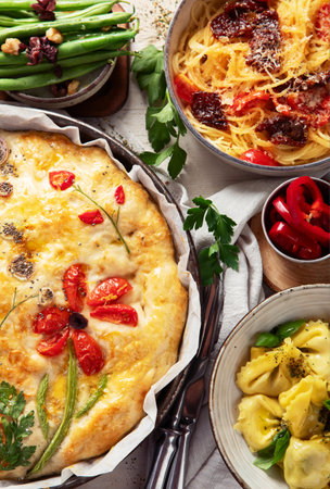 Table of Italian meals. Pizza, pasta, ravioli, focaccia on white background. Healthy eating concept. Top view.の写真素材