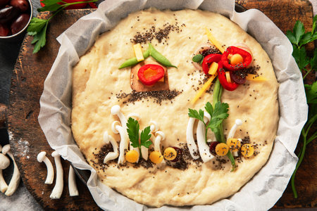 Italian food cooking. Raw focaccia art on dark background. Top viewの写真素材