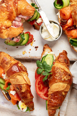Set of tasty sweet and salty croissant sandwiches on white background, top view.の写真素材