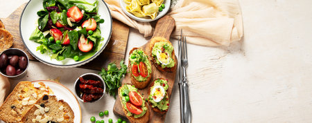 Assortment of various dinner food. Vegetarian seasonal summer food. Top view. Panorama with copy space.の写真素材