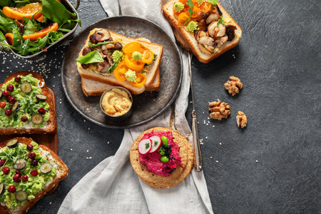Vegan toast with avocado,mushroom and fresh salad on dark background. Vegetarian food concept. Top view, copy spaceの写真素材