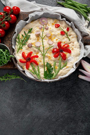Raw focaccia art on dark background. Italian food concept. Top view, copy spaceの写真素材