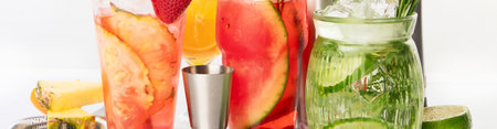 Spring or summer refreshing cold cocktails or mocktails with berries and fruits on a white background. Top view. Panorama.の写真素材