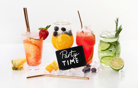 Spring or summer refreshing cold cocktails or mocktails with berries and fruits on a white background. Top view.の写真素材