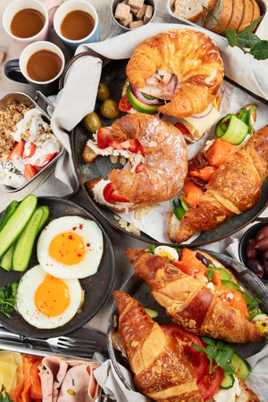 Breakfast served with coffee, croissants, eggs and snacks on a white background. Balanced diet. Top view.の写真素材