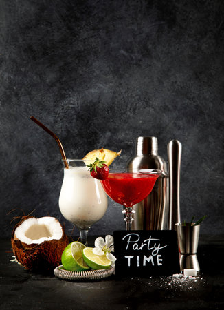 Summer cocktails in classic glasses on a black background. Party time. Tasty drinks. Copy spaceの写真素材