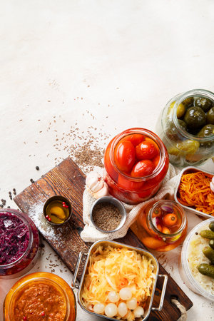Fermented products on a wooden background. Pickled vegetables in jars. Top view, copy spaceの写真素材