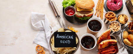Various of american food, French fries, hamburgers, chips, popcorn, snacks and sauces on a white background, top view. Panorama with copy space.の写真素材