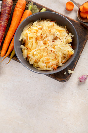 Winter salad on wooden light background. Homemade sauerkraut cabbage with carrot. Tasty food. Top view, copy spaceの写真素材