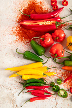 Colorful raw peppers on a light wooden background. Delicious vegetables concept. Top viewの写真素材