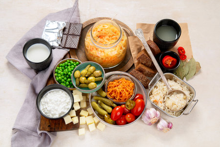 Probiotic food concept. Cabbage in jar, pickle, carrot on light wooden background. Top viewの写真素材