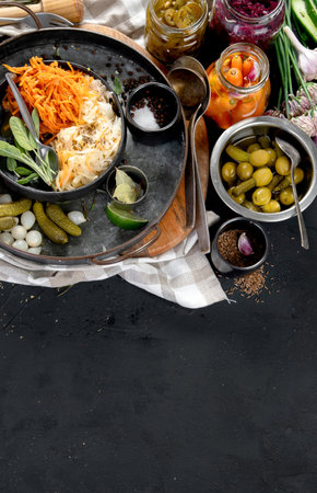 Fermented products on a dark background. Pickled vegetables in jars. Top view, copy spaceの写真素材