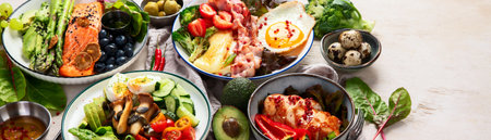 Healthy food, keto diet, diet lunch concept. Assortment of various healthy keto meals Top view on white background. Panorama with copy space.の写真素材