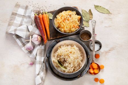 Winter salad on wooden light background. Homemade sauerkraut cabbage with carrot. Tasty food. Top viewの写真素材