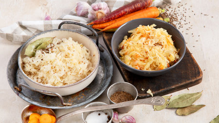 Winter salad on wooden light background. Homemade sauerkraut cabbage with carrot. Tasty food.の写真素材