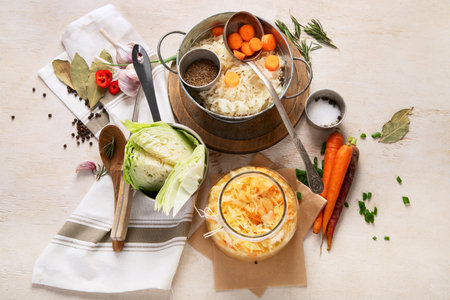 Winter salad of marinated cabbage and carrot Homemade sauerkraut in a jar on wooden background. Top viewの写真素材