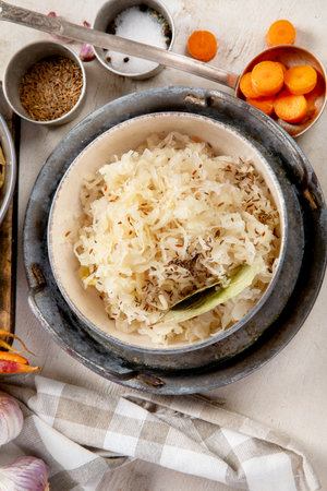 Winter salad on wooden light background. Homemade sauerkraut cabbage with carrot. Tasty food. Top viewの写真素材