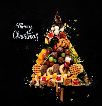 Christmas tree with sweets and cookies decoration on dark background. Holiday food. Top view.の写真素材