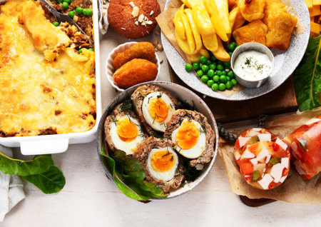 Variety of classic traditional British dishes. Meals good for lunch, snack and dinner on a light background. Top view. Panorama with copy space.の写真素材